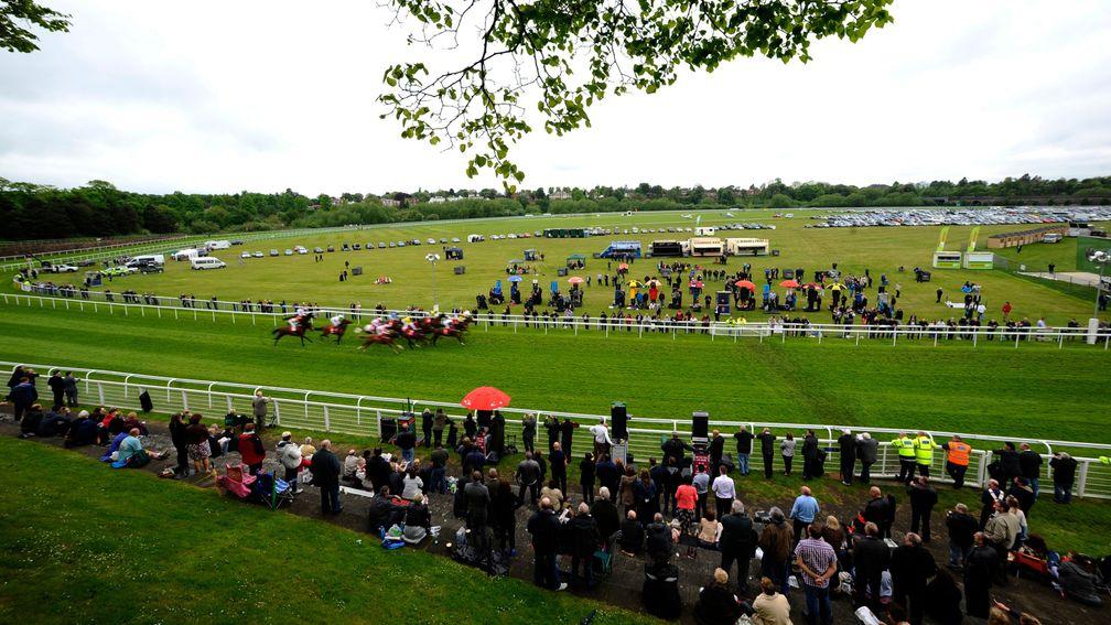 CHESTER, ENGLAND - MAY 08: Runners make their way past the crowd in the silver ring in The IG Handicap Stakes  at Chester racecourse on May 08, 2014 in Chester, England. (Photo by Alan Crowhurst/Getty Images)