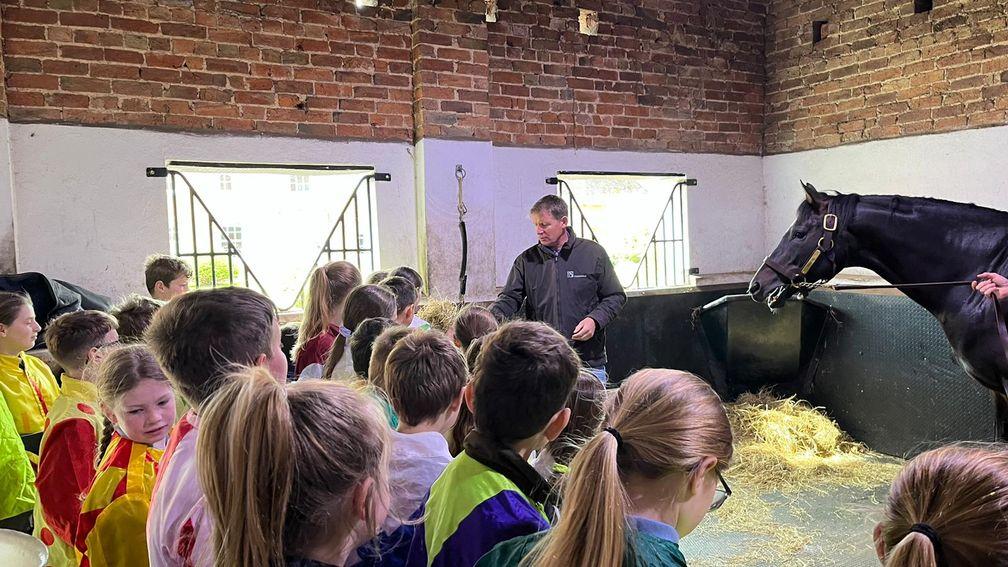 The students gathered in Kameko's stable during the Racing to School visit to Tweenhills