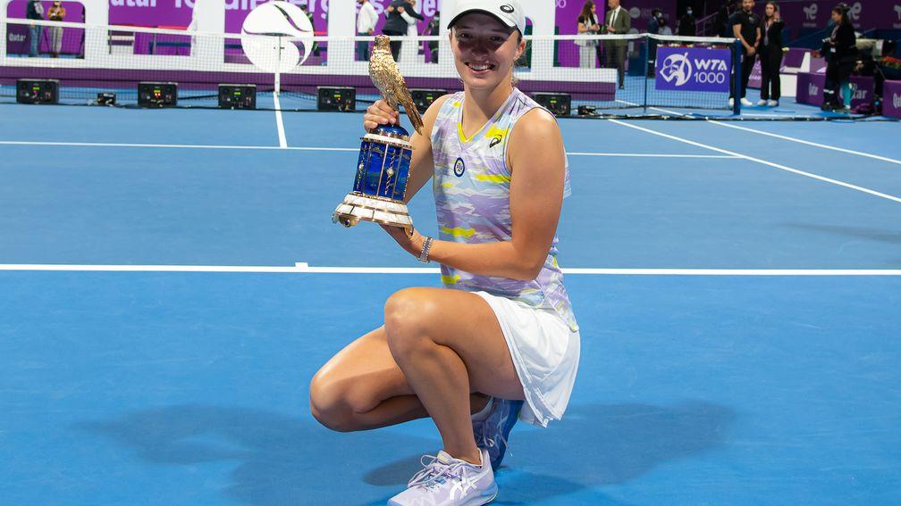 Iga Swiatek poses after winning the the first of her two Qatar Open titles