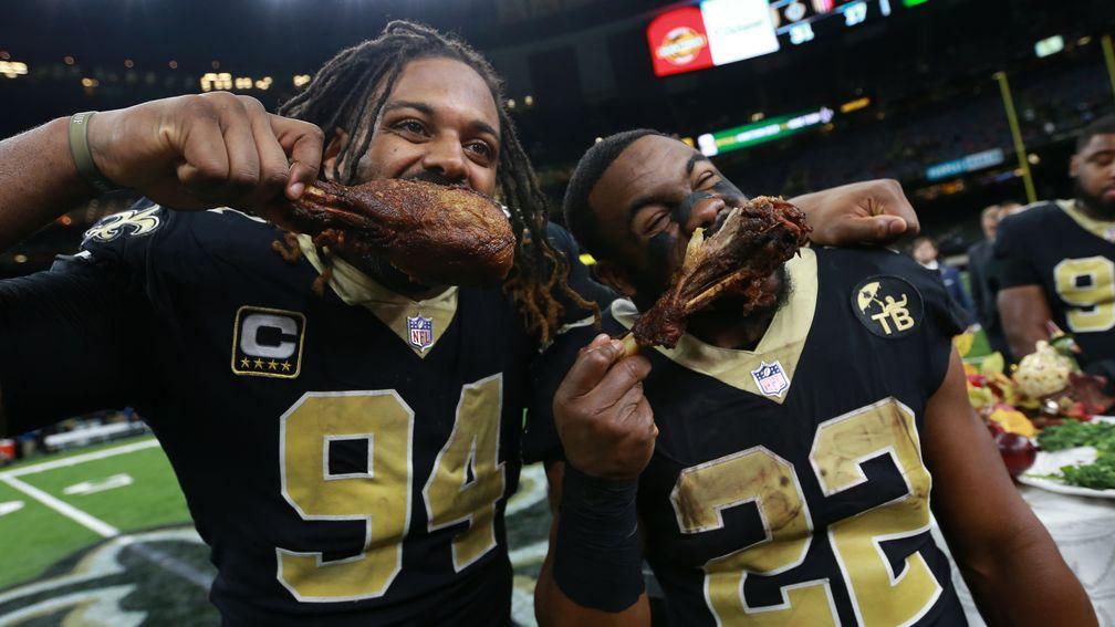 New Orleans Saints' Cameron Jordan and Mark Ingram enjoy turkey after their Thanksgiving triumph
