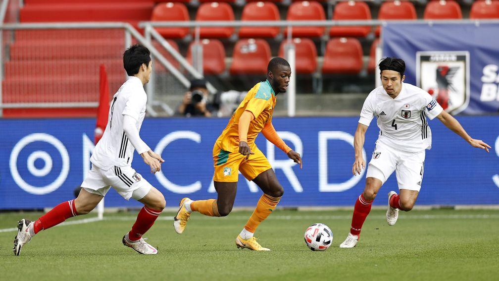 Nicolas Pepe of Ivory Coast takes on Japan's defence