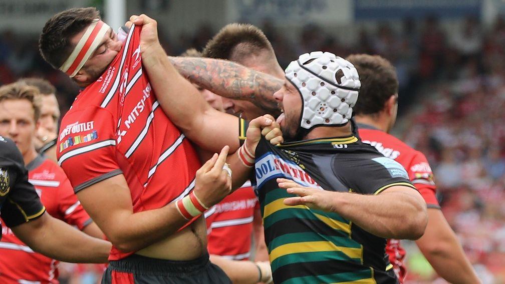 Heinrich Brussow (right) of Northampton Saints tussles with Gloucester's Lewis Ludow