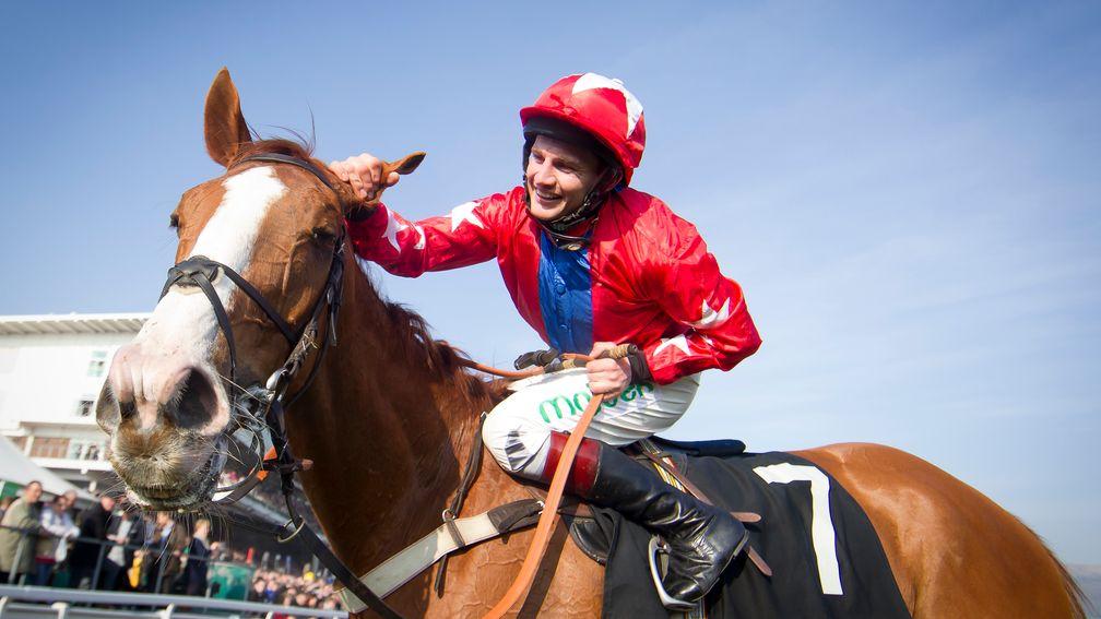 Jamie Moore pats Sire De Grugy affectionately after victory in the 2014 Champion Chase