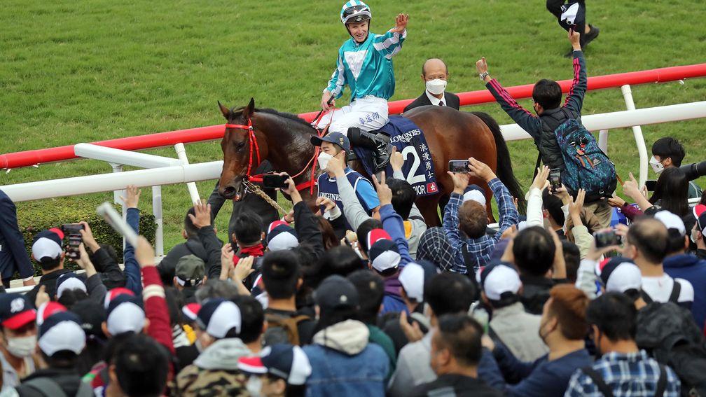 Romantic Warrior and James McDonald salute the crowd after winning the Hong Kong Cup