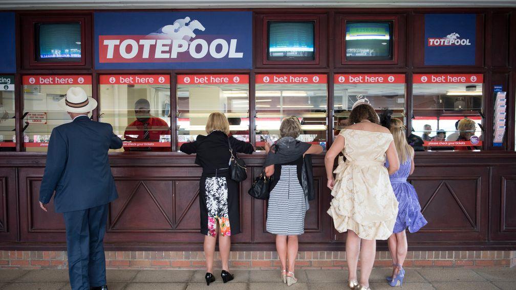 Punters prepare to place their bets on the Tote