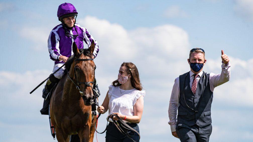 Snowfall with Ryan Moore, Aimee Butler and Ballydoyle travelling head lad Pat Keating after winning the Juddmonte Irish Oaks at the Curragh
