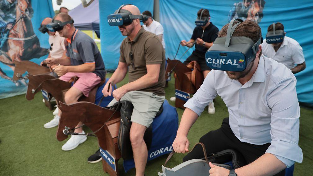 Sam Hendry checking out and trying the Coral JockeyCam virtual reality equipment at Sandown with six other wannabe jockeys