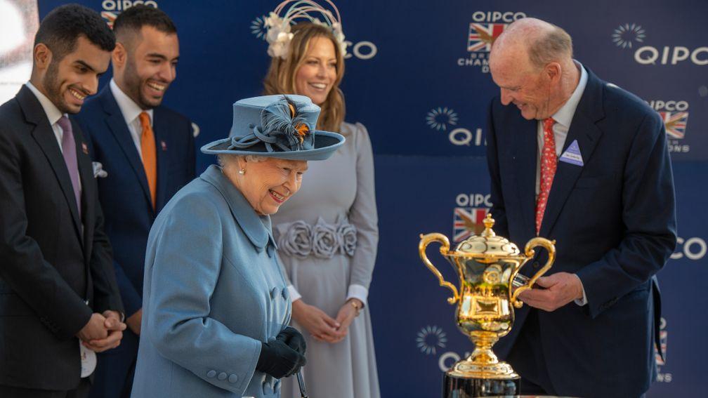 The Queen presents the QEII trophy to John Gosden and connections of Roaring Lion at Ascot on Saturday