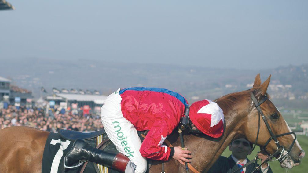  Jamie Moore hugs Sire De Grugy affectionately as the pair win the Queen Mother Champion Chase Cheltenham Festival Day 2 Photo: Patrick McCann 12.03.2014 