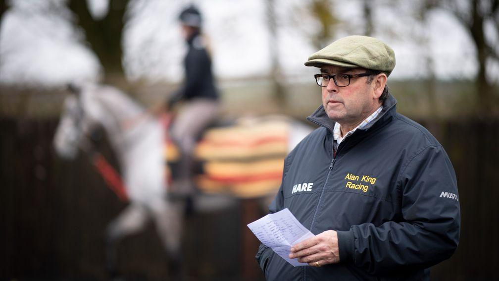Alan King consults the list as he marshals second lot at his Barbury Castle yard