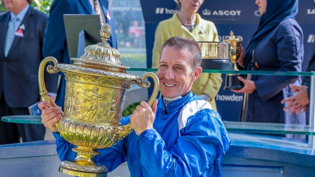 Jim Crowley holds up the trophy after Hukum wins
the King George VI and Queen Elizabeth Qipco Stakes