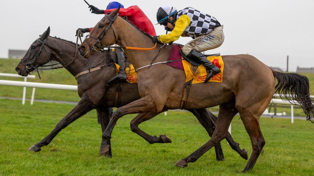Jungle Boogie and Darragh O'Keeffe near side) pass Classic Getaway on the run in to win the Savills New Year's Day Chase