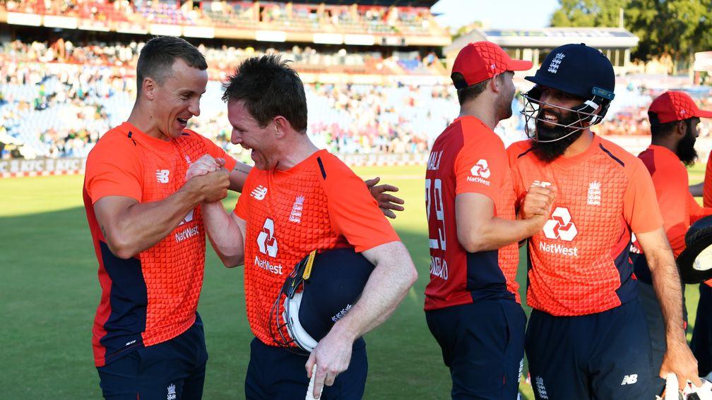 Tom Curran and Eoin Morgan (left) celebrate England's T20 series win in South Africa