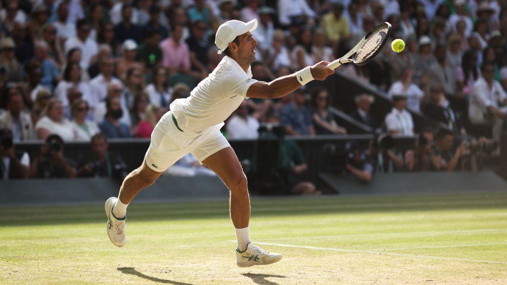 Novak Djokovic reaches out wide to play a forehand on his way to a four-set semi-final victory over Britain's Cameron Norrie on Centre Court on Friday