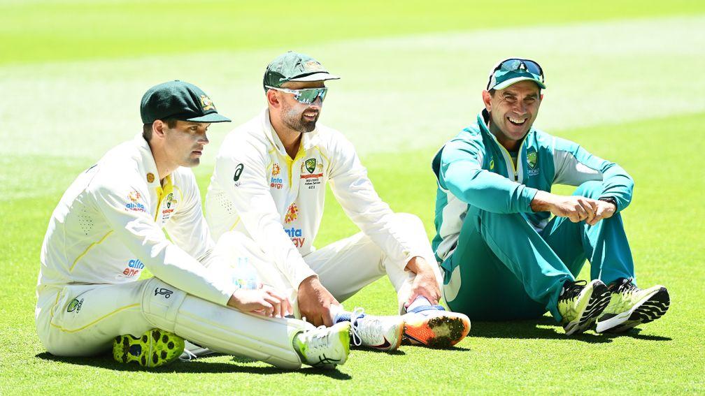 Alex Carey (left), Nathan Lyon and coach Justin Langer savour Australia's win at the MCG