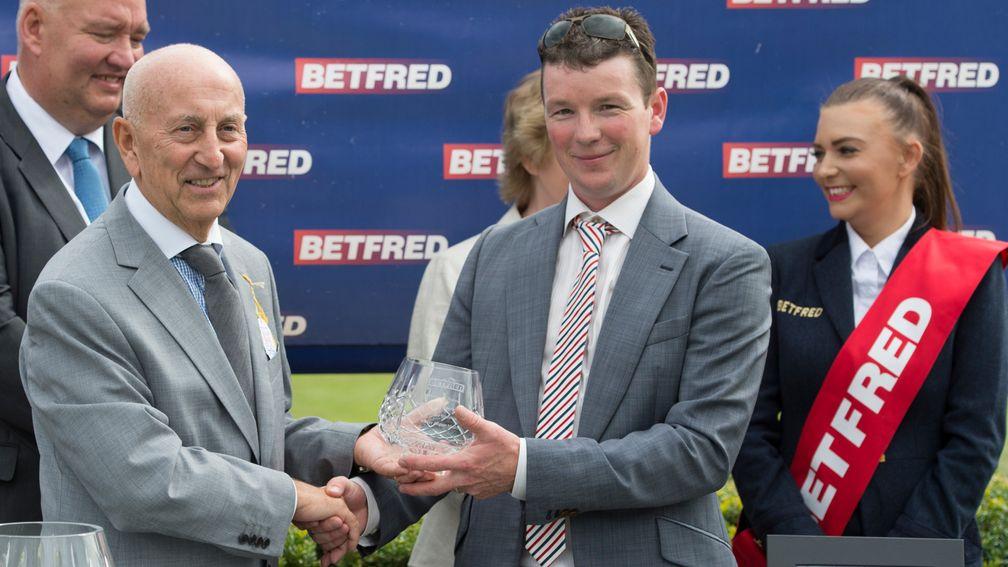 Fred Done (left), pictured presenting trainer David Griffiths with his prize after Take Cover's victory in the 2014 King George Stakes at Goodwood, stressed the importance of bookmaker sponsorship to racing
