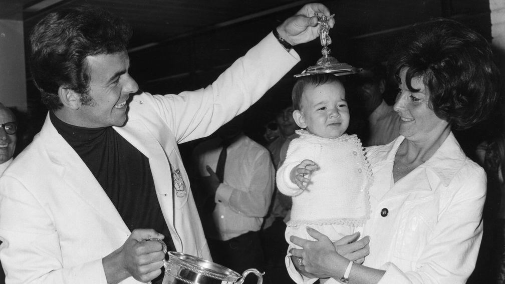 Tony Jacklin fitting the lid of the US Open trophy on to his son Bradley's head in 1970