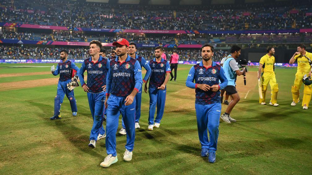 Afghanistan's players leave the field after their three-wicket loss to Australia