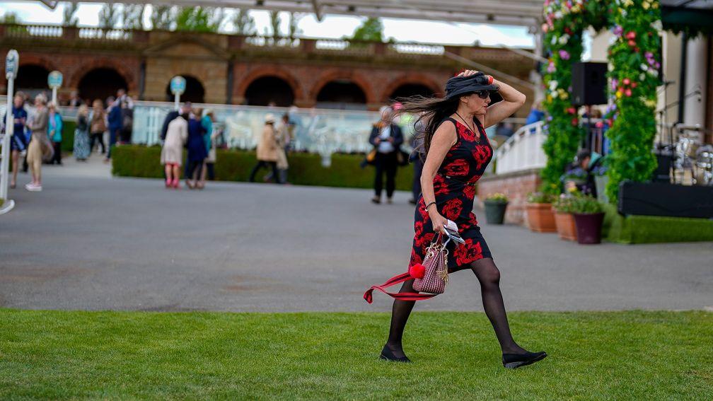 YORK, ENGLAND - MAY 11: A racegoer makes her way to the grandstands at York Racecourse on May 11, 2022 in York, England. (Photo by Alan Crowhurst/Getty Images)
