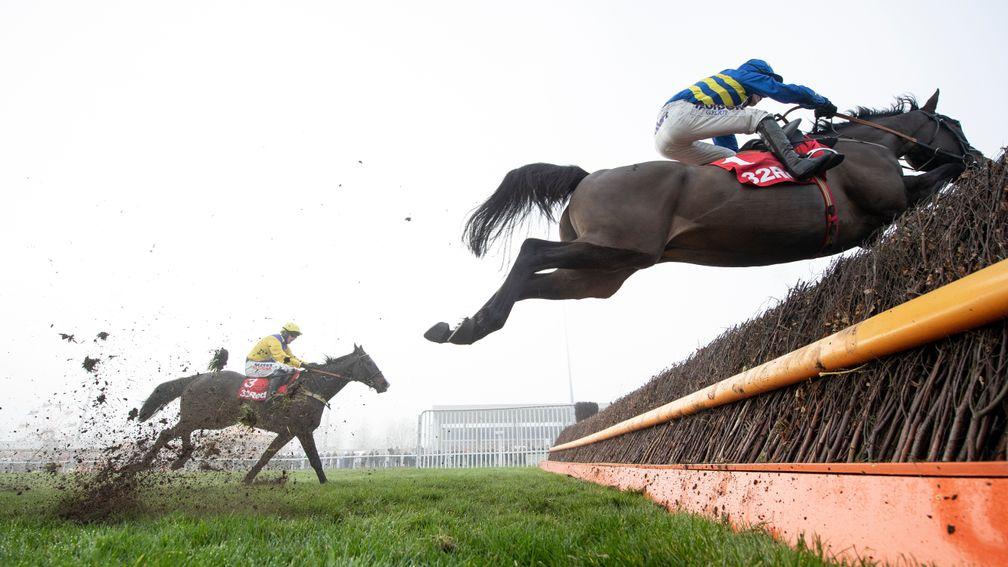 Dynamite Dollars (Harry Cobden) soars over the last fence and beats Kalashnikov in the Wayward Lad Novices Chase