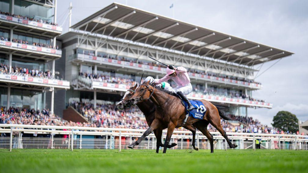 Warm Heart (nearest) and Free Wind battle all the way to the line in the Yorkshire Oaks