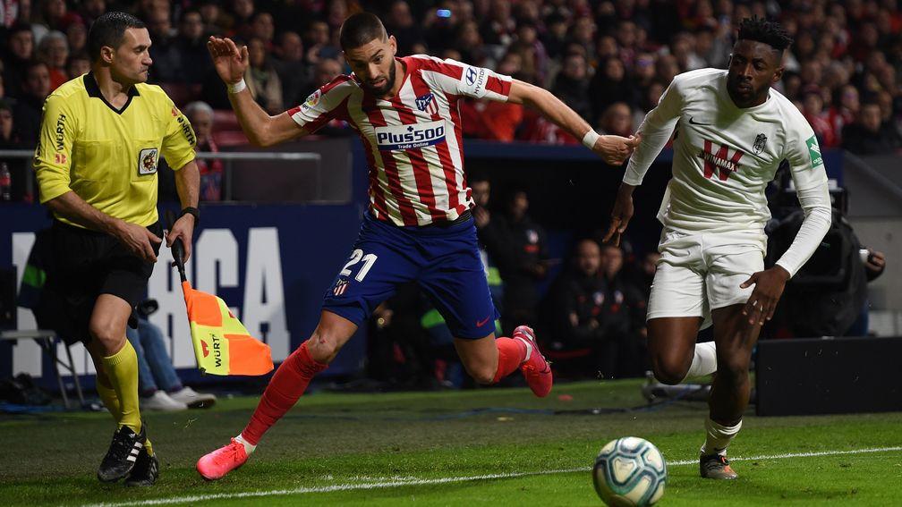 Yan Brice of Granada battles for possession with Yannick Carrasco of Atletico Madrid