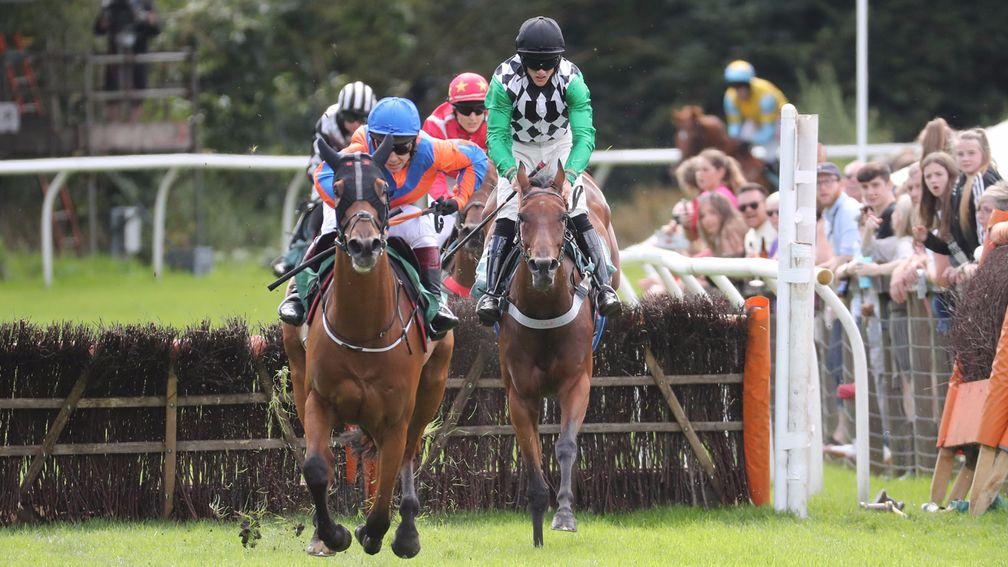 Golden Jeffrey ridden by Ross Chapman (black cap) jumps the final flight in second place before going on to overhaul Knockmaole Boy and Richard Johnson on the run in.