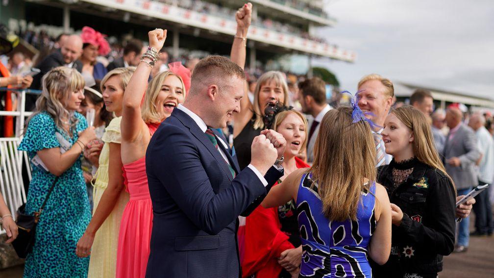 YORK, ENGLAND - AUGUST 19: Racegoers show delight after a winner at York Racecourse on August 19, 2021 in York, England. (Photo by Alan Crowhurst/Getty Images)