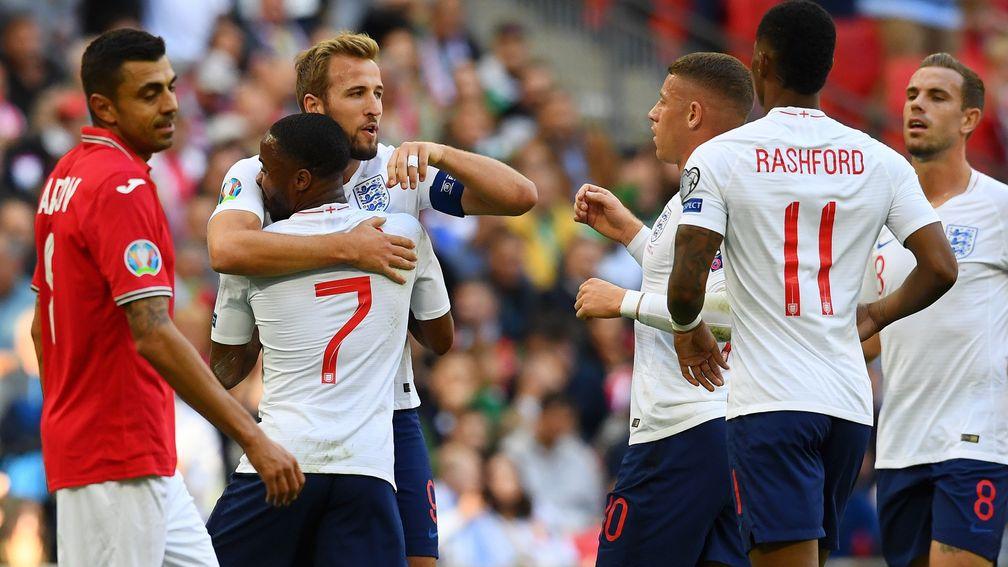 Harry Kane of England celebrates scoring the first goal with Raheem Sterling