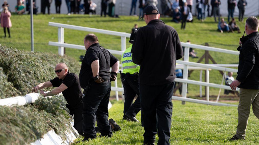 Jockey Club security check fence two for potential devices after activists broke on to the track before the Grand National