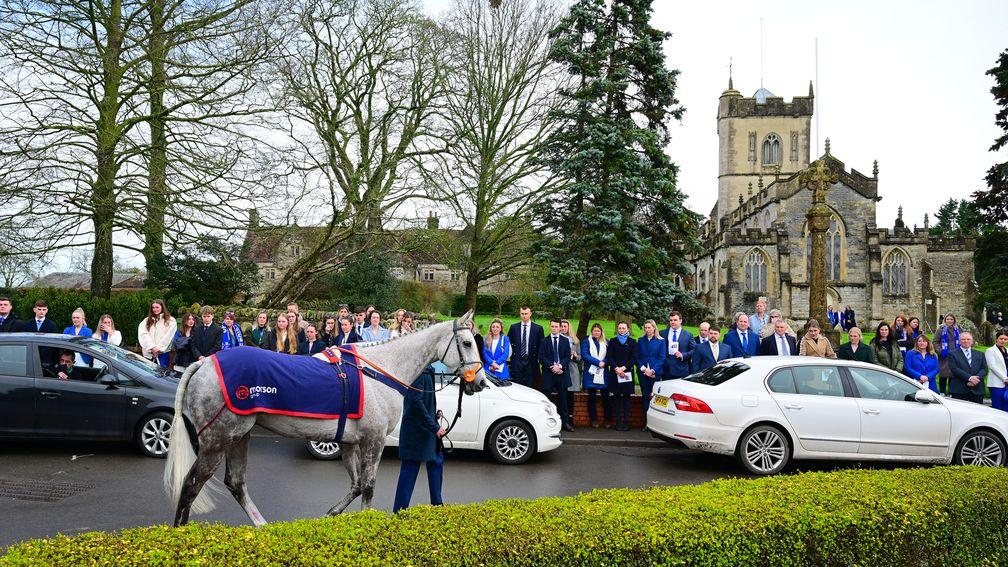 Staff from Paul Nicholls' yard line the street as Highland Hunter leads the Keagan Kirby's funeral procession to St Mary Magdalene church