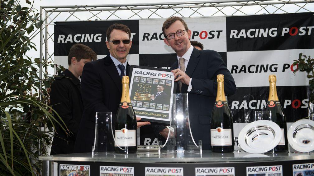 Racing Post chief executive Alan Byrne with Aidan O'Brien on the victory podium after Saxon Warrior's 2017 Racing Post Trophy triumph