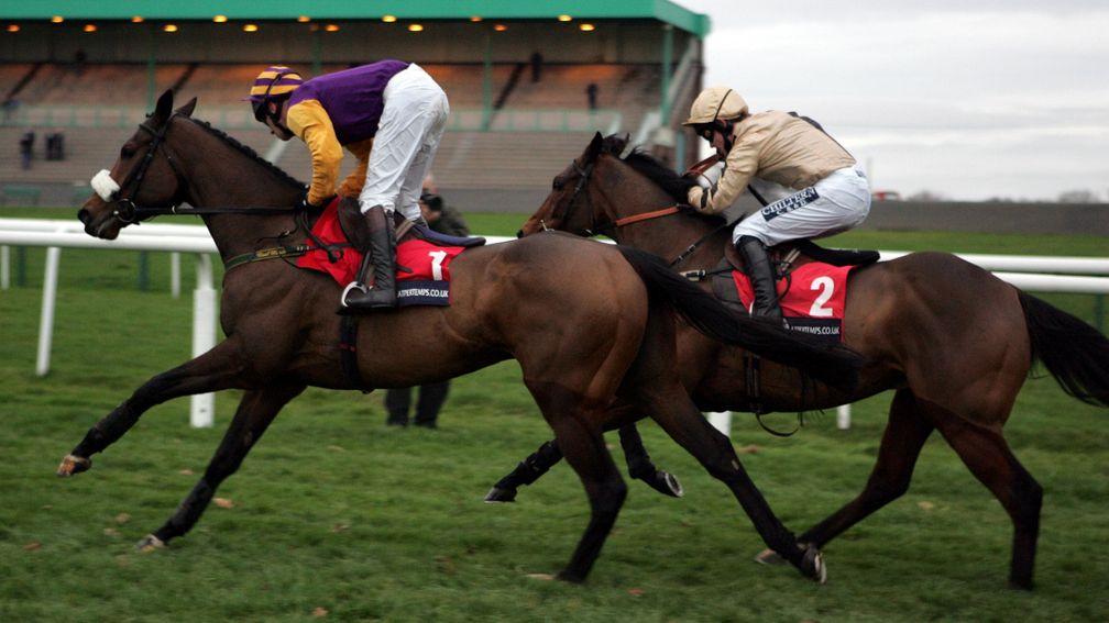 HARCHIBALD and Paul Carberry (purple and gold) sits motionless asthey draw clear of a hard ridden Inglis Drever (G.Lee) to win the Pertempts Fighting Fifth Hurdle(Grade 1) at Newcastle 27/11/04 Photograph by John Grossick The Steadings, Rockhallhead Collin, Dumfries DG1 4JW  tel. 01387750512