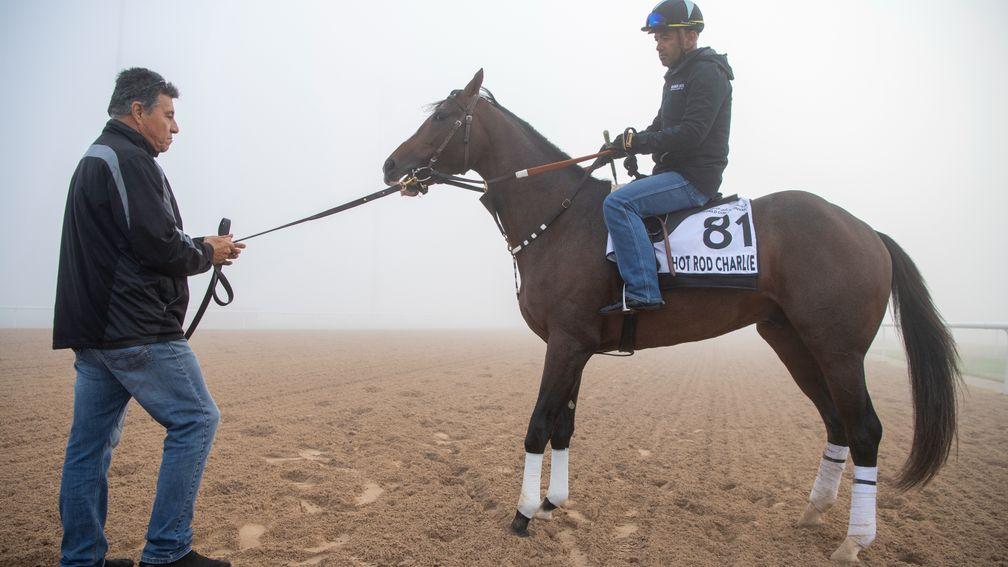 Hot Rod Charlie (Antonio Romero) with assistant trainer Leandro Mora after exercising at a foggy Meydan - he is heading further east now to Japan