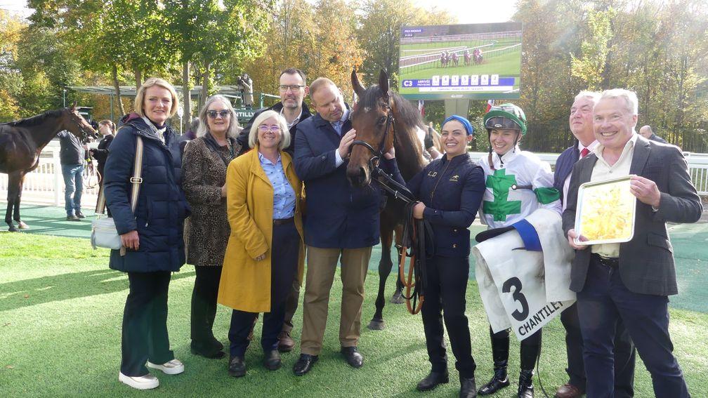 David Menuisier and Marie Velon are surrounded by happy members of the Quantum Leap syndicate after Tamfana wins the G3 Prix Miesque