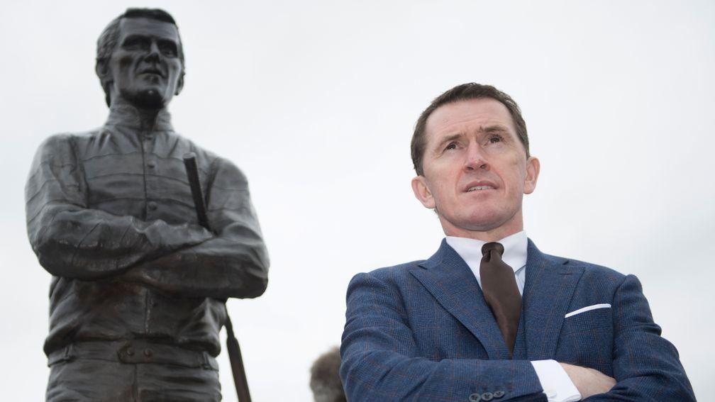 Sir AP McCoy and his statue Cheltenham 14.3.17 pic: Edward Whitaker