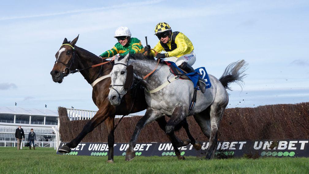 Elixir De Nutz (right) runs on from the last fence and beats Jonbon in the Clarence House Chase