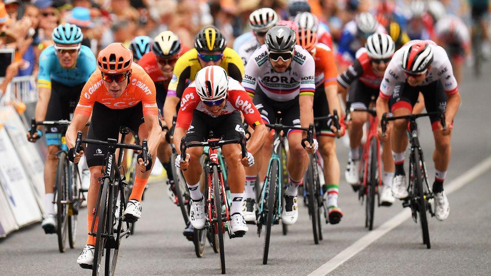 Caleb Ewan (centre) is touched off in a sprint finish by Patrick Bevin during the Tour Down Under
