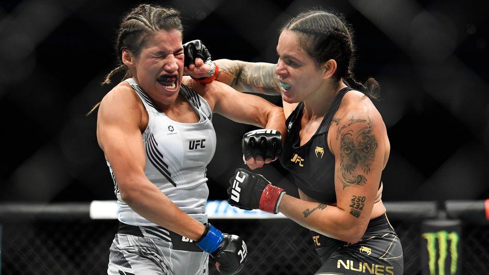 Amanda Nunes (R) catches Julianna Pena with a right hand in their first fight