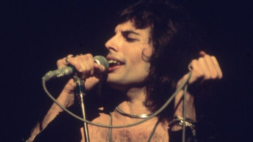 Freddie Mercury, flamboyant frontman of Queen, helps Adam Wedge celebrate a winner