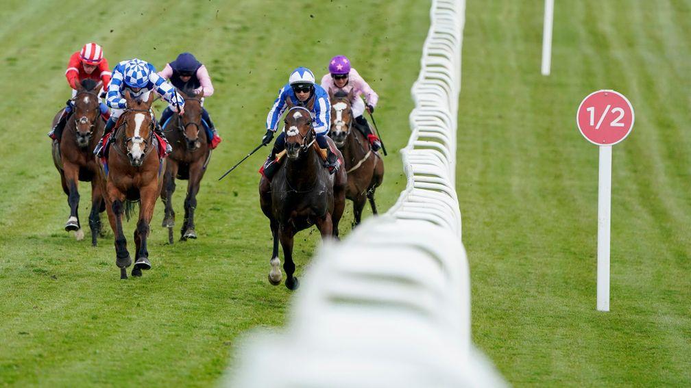 EPSOM, ENGLAND - APRIL 20: Silvestre De Sousa riding Group One Power (R, blue/white) win The Great Metropolitan Handicap at Epsom Racecourse on April 20, 2021 in Epsom, England. Sporting venues around the UK remain under restrictions due to the Coronaviru