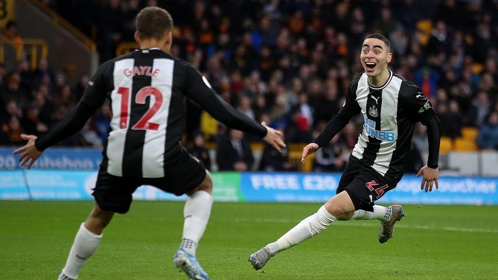 Newcastle United's Miguel Almiron celebrates a goal with Dwight Gayle