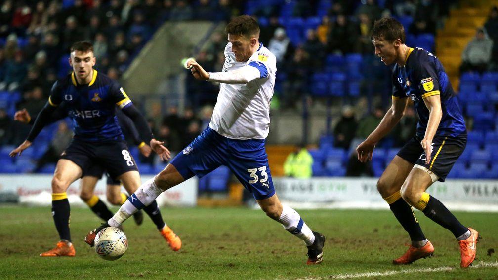 Tranmere's Andy Cook under pressure from Tom Anderson (right) of Doncaster