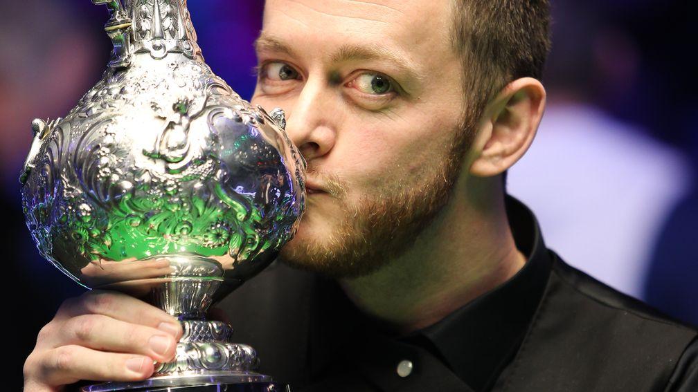 Mark Allen lays a kiss on the World Grand Prix trophy 