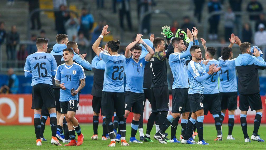 Uruguay players thank the fans after their draw with Japan in Porto Alegre