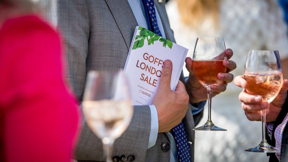 Rosé and research material: a prospective purchaser clutches his London Sale catalogue