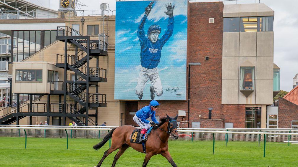 Trawlerman: on the way to the stalls with the Frankie Dettori mural behind him