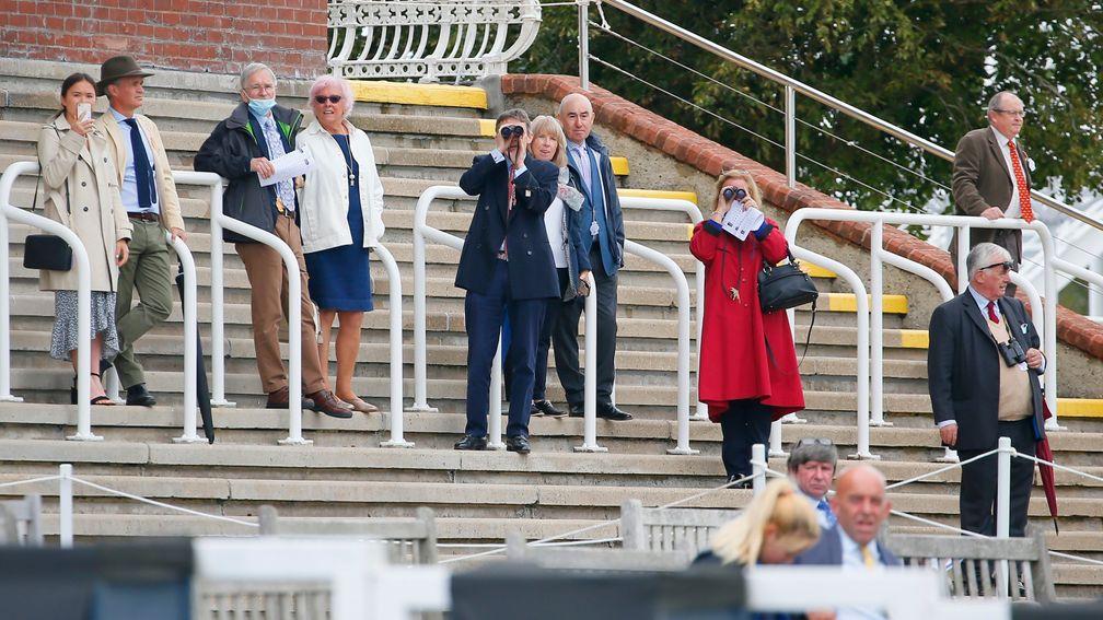Owners watch the action at a behind-closed-doors meeting at Goodwood last month