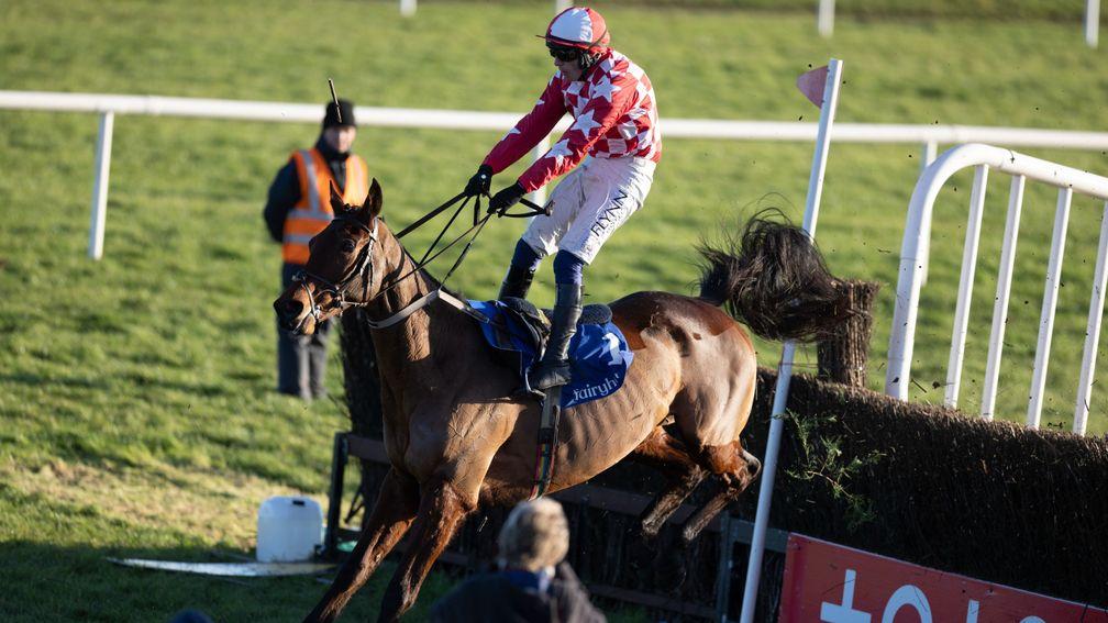 Flying high: Paul Townend manages to hold on to Flame Bearer at the last fence