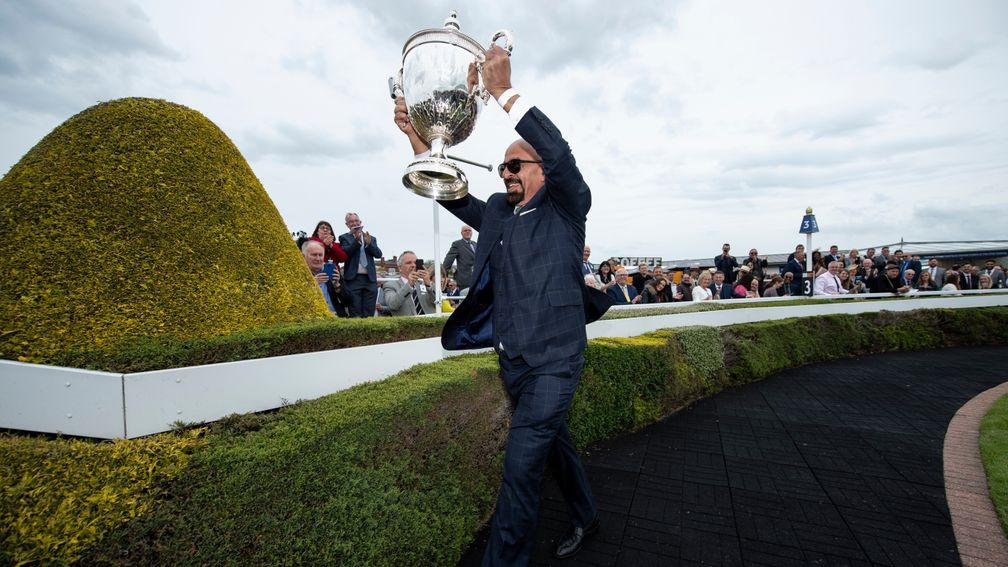 Chester Cup-winning owner Marwan Koukash shows off the trophy